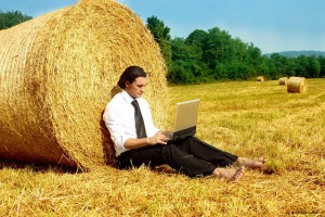 Предприниматель с ноутбуком в поле